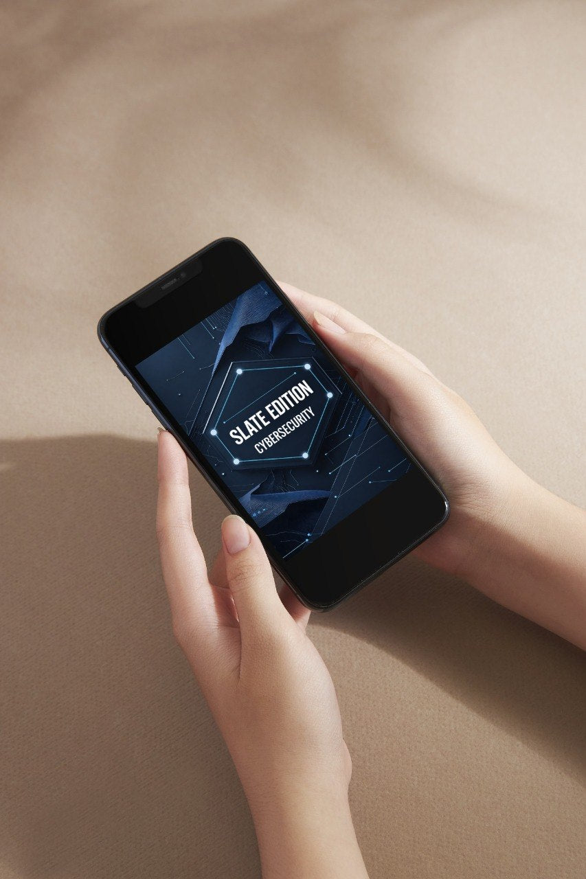 A person holds a black smartphone showing a dark blue digital design template on the screen against a warm beige background.